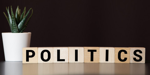 POLITICAL message word on a wooden desk on cube blocks