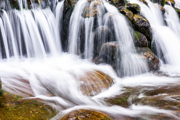 Fototapeta premium The stones under the waterfall, close-up waterfall as background.