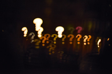 Glowing question marks qustom bokeh. Question concept. City street lights