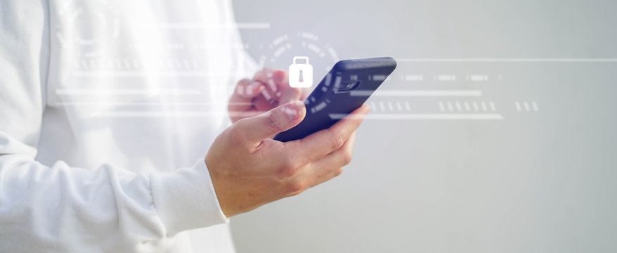 close up programmer man hand hold smartphone to register data system or access password with virtual interface protection of cyber security at operation room , futuristic technology concept