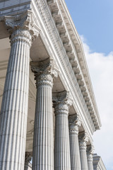 Close-up Roman-style stone pillars building.