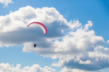 Paragliding in the sky on a sunny day.