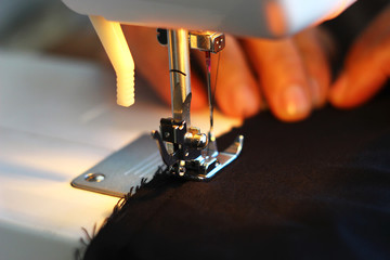 Hands working on the sewing machine