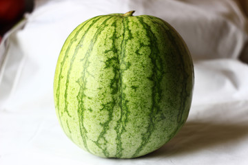 Close up of a native watermelon on white fabric