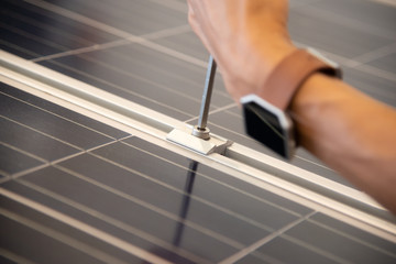 mounting and install solar cell power system by screw driver stock photo