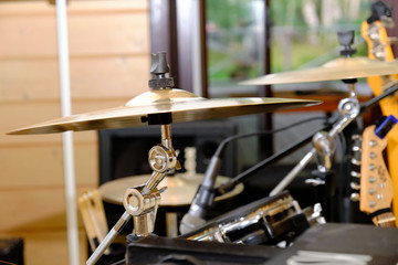 Closeup gold plate of the drum set in recording studio. 