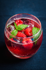 Raspberry and mint cocktail in glass on the rustic background. Selective focus. Shallow depth of field.
