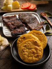 Arepa of yellow corn with oreada or roasted meat. typical food of Colombia