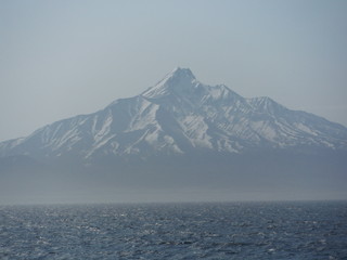snow covered mountains over ocean