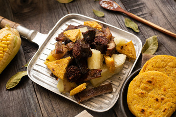 minced meat with meat, chicken, blood sausage, yellow corn arepa (picada de carnes)