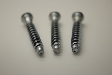 screws and nuts for furniture on a white background