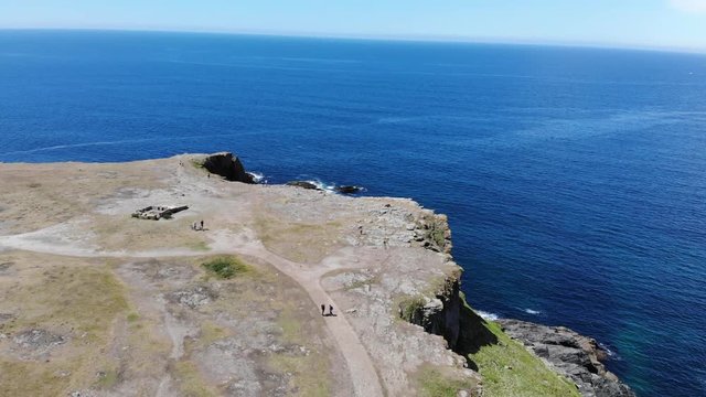 cinematic aerial drone shot of Groix island, home to a wide variety of sea birds. Located in Morbihan and accessible by sea from Lorient, the island of Groix is ​​welcoming and warm. 