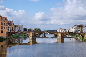 Fototapeta na wymiar Arno River with Ponte Santa Trinita from Ponte Vecchio. Florence, Italy. The oldest elliptic arch bridge in the world.