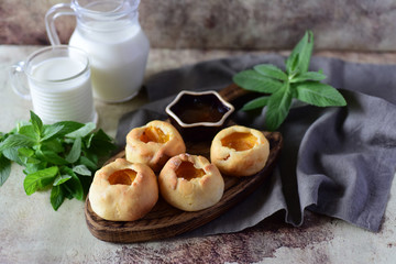 Cheesecakes with apricots on a wooden Board on a gray background