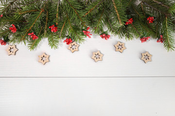 Fototapeta na wymiar Wide arch shaped Christmas border isolated on white, composed of fresh fir branches and ornaments in red. wooden Christmas stars eco-materials