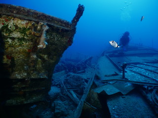 scuba divers exploring shipwreck scenery underwater ship wreck deep blue water ocean scenery of...