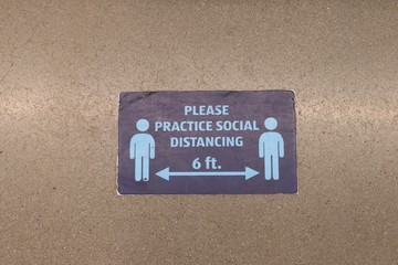 Six foot social distancing sign on the floor in a building