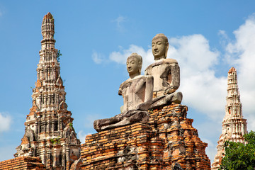 Remains of ancient temples in the historical site Ayutthaya in Thailand - obrazy, fototapety, plakaty