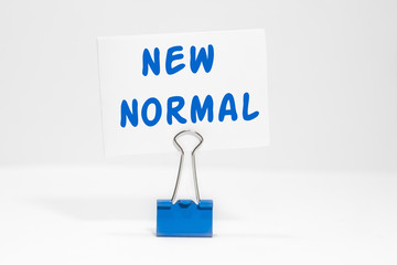 NEW NORMAL text on an endless white background with a blue heat
