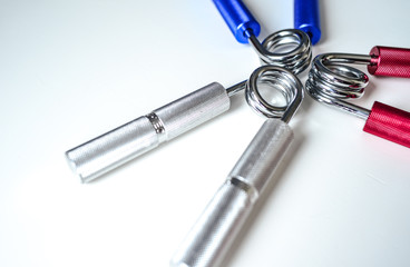 Expanders of different colors depending on the load with or without a hand. Sports and physical activity