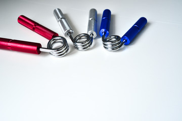 Expanders of different colors depending on the load with or without a hand. Sports and physical activity