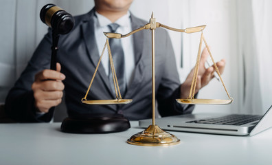 Business and lawyers discussing contract papers with brass scale on desk in office. Law, legal...