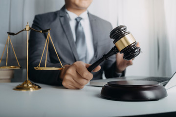 Business and lawyers discussing contract papers with brass scale on desk in office. Law, legal services, advice, justice and law concept picture with film grain effect