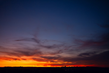 Cirrus clouds in the twilight . Evening sky in the city 