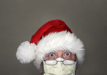 Santa wearing a mask protecting from viruses, remote internet view