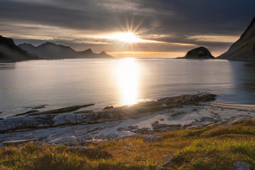 sunset on a paradise beach Haukland with white sand, and mountains the Lofoten Islands in polar Norway