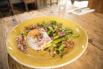 Starter fried egg with micro greens and asparagus bistro pub starter meal