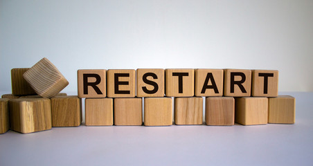 Concept word 'restart' on cubes on a beautiful wooden table. White background. Business concept.