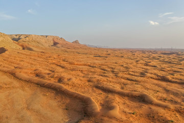 Obraz na płótnie Canvas Drone view of Dry Desert in Dubai with Sand Ripples, High Dune Desert in United Arab Emirates 