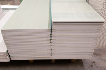 Pallet with Drywall sheets plasterboard in the building warehouse store