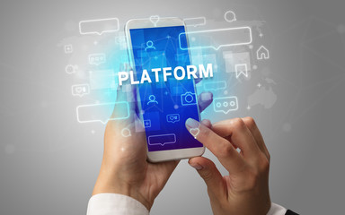 Female hand typing on smartphone with PLATFORM inscription, social media concept