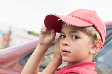 A little boy in a red t-shirt and cap © Сергей Старостов