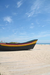Fototapeta premium Typical fishing boat on the Costa da Caparica Beach, near Lisbon, Portugal.