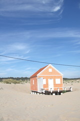 Typical tiny wooden colorful house, in Costa da Caparica, Lisbon, Portugal.