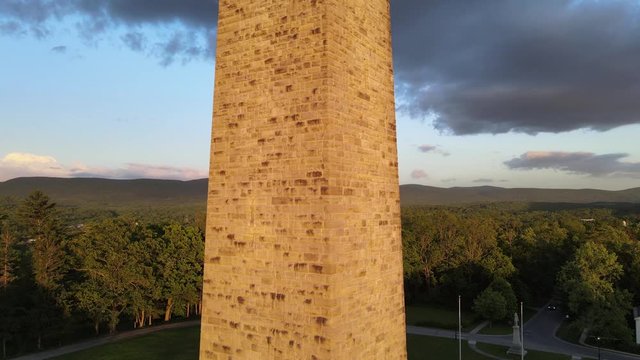 Aerial close-up video of tall stone monument. Drone slowly rising upwards filmed in Bennington, Vermont.