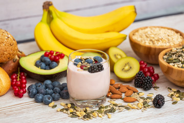 Group Fruits Breakfast with bread Whole grains and nuts, yogurt mix with Cherry , banana, avocado in the wooden table. Breakfast for Health and Diet concept
