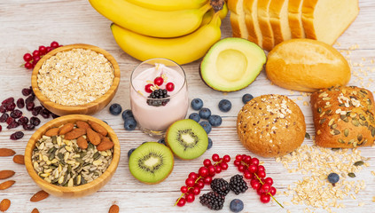 Group Fruits Breakfast with bread Whole grains and nuts, yogurt mix with Cherry , banana, avocado in the wooden table. Breakfast for Health and Diet concept