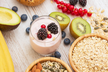 Group Fruits Breakfast with bread Whole grains and nuts, yogurt mix with Cherry , banana, avocado in the wooden table. Breakfast for Health and Diet concept