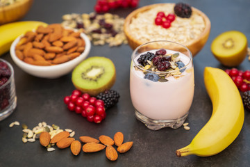 Group Fruits Breakfast with bread Whole grains and nuts, yogurt mix with Cherry , banana, avocado in the wooden table. Breakfast for Health and Diet concept