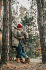 Hiking couple with backpack walking in the forest and exploring outdoors. Freedom and active travel concept.