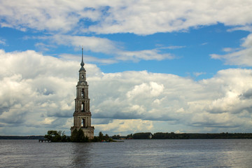 A bell tower submerged in the river in Kalyazin Russia against a cloudy dramatic sky and space for copying