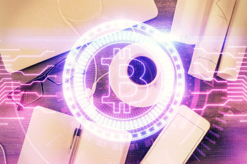 Blockchain theme hologram drawings over computer on the desktop background. Top view. Multi...