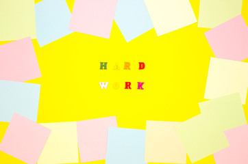 The concept of motivation, work. The words HARD WORK in the center on a yellow background, colored...