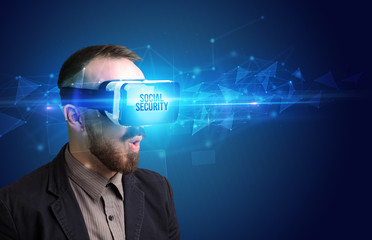 Businessman looking through Virtual Reality glasses with SOCIAL SECURITY inscription, cyber security concept