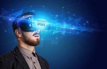 Businessman looking through Virtual Reality glasses with SECURITY UPDATE inscription, cyber security concept