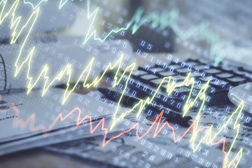 Double exposure of financial chart drawings and desk with open notebook background. Concept of...
